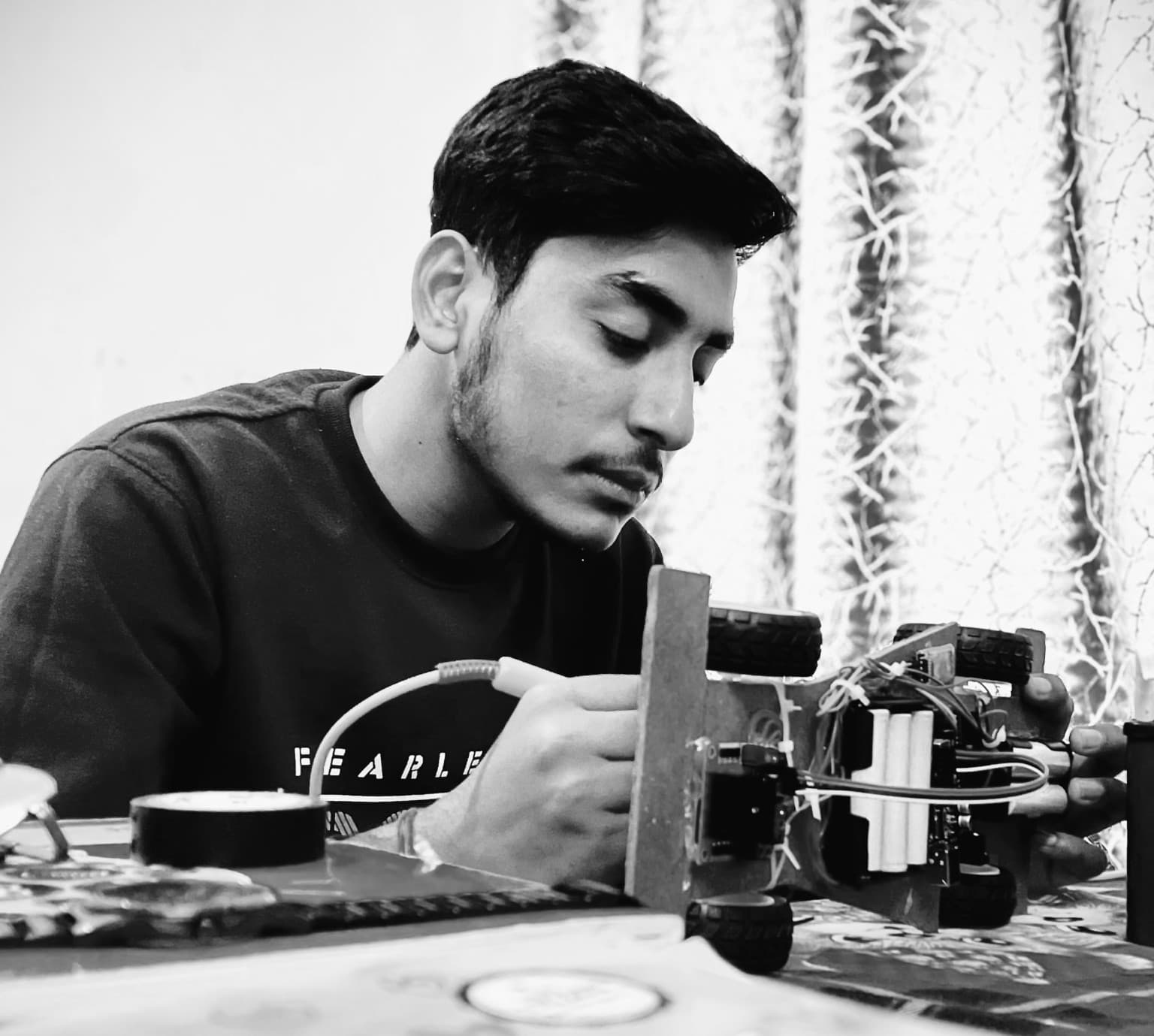 Rinku Diwakar soldering and wiring an autonomous hardware robotics system